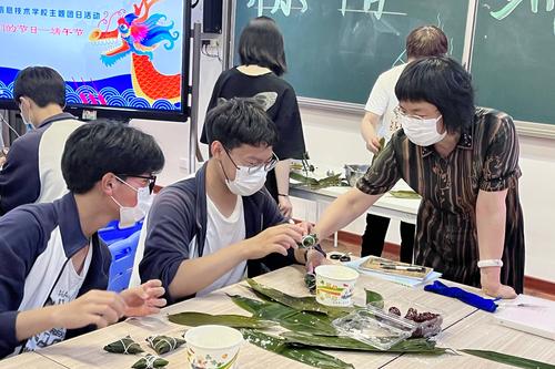 2.校长韦艳春与同学们一起包粽子 2.校长韦艳春与同学们一起包粽子